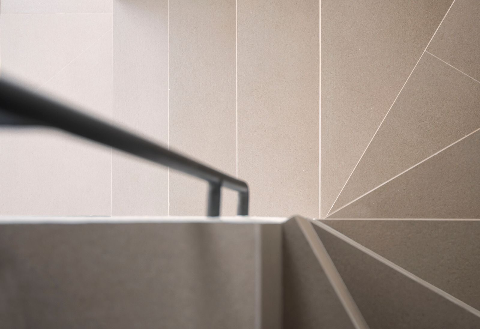 Minimalist staircase with geometric patterns and railing, ideal for contemporary designs.