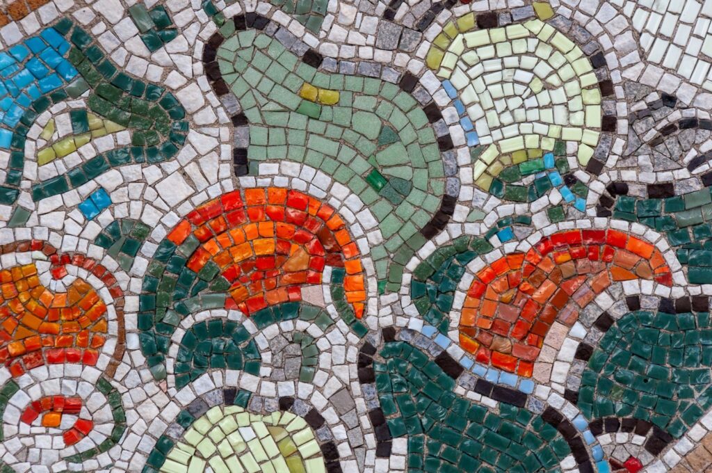 Vibrant mosaic artwork featuring an abstract geometric design in multicolored tiles.