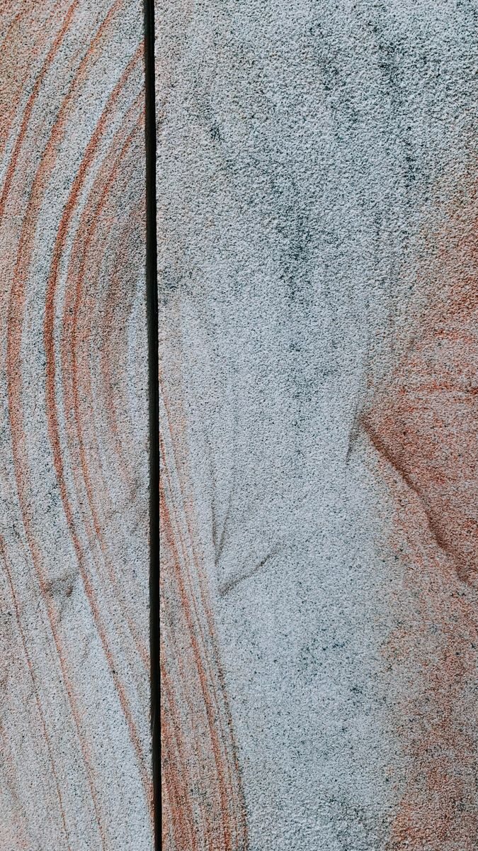A detailed texture of a stone surface with colorful lines, perfect for backgrounds.